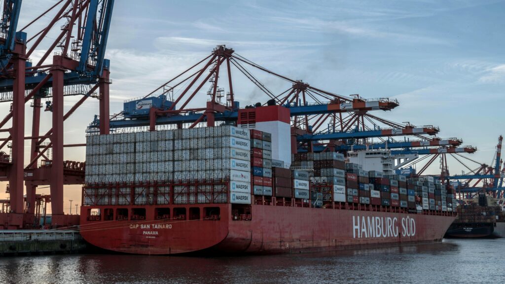 Massive container ship docked at Hamburg Port, showcasing logistics and global trade.